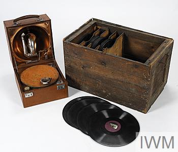 Portable Decca gramophone and 32 records stored inside a wooden box originally for ammunition