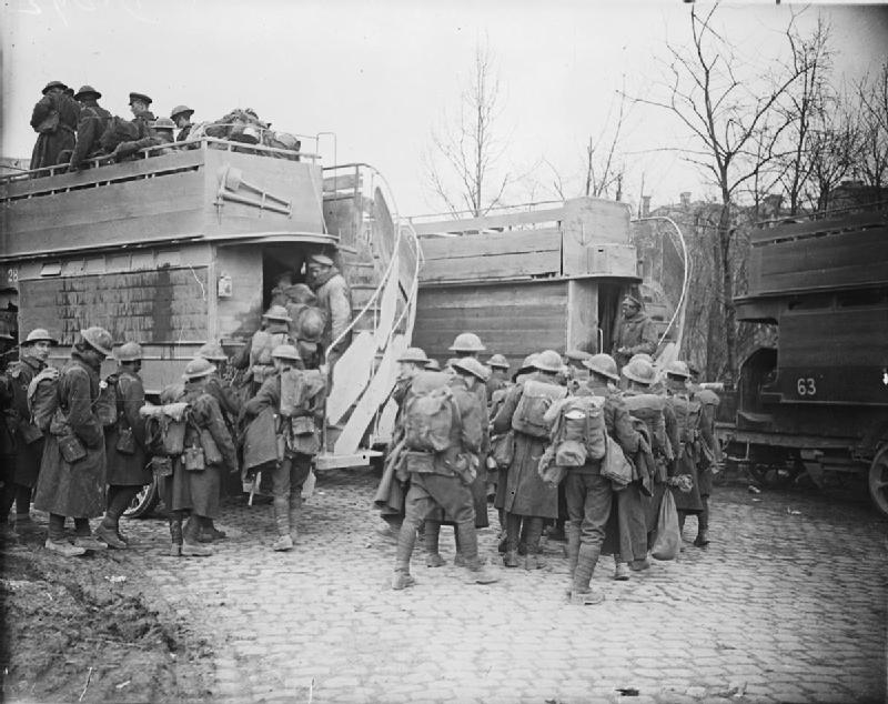 British troops embussing in Arras to go back for a rest, May 1917. The buses being used are London 'B' type buses, some 1,300 of which were requisitioned by the army in October 1914 as troop-carriers on the Western Front. John Warwick Brooke. Q 5238