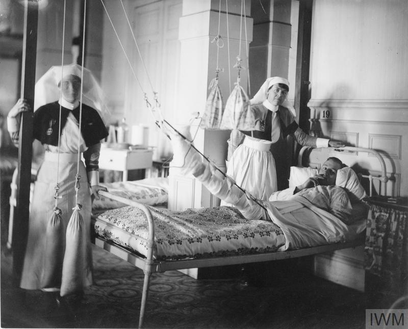 Sisters of the Queen Alexandra’s Imperial Military Nursing Service with a patient © IWM (Q 108213)